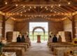 Charming rustic barn wedding venue with warm lighting and floral decorations